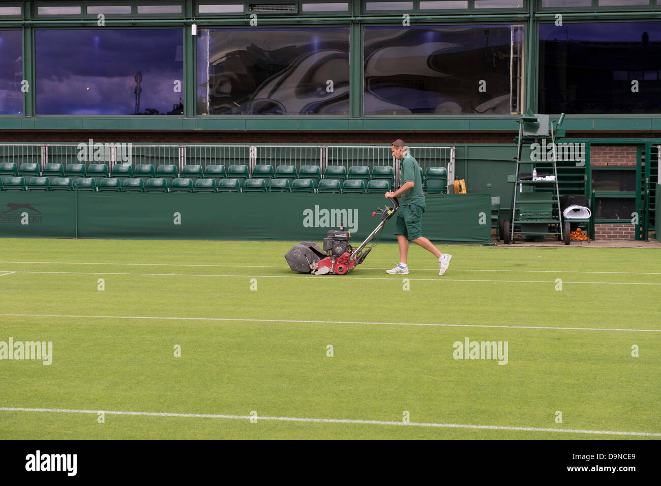 London, UK. 23. Juni 2013. Wimbledon Tennis Championships 2013 statt in The All England Lawn Tennis and Croquet Club, London, England, UK. Allgemeine Ansicht (GV). Ein Garten-Mann mäht den Rasen des Hofes Nr. 18 in Vorbereitung für den Start der Meisterschaften Morgen. Bildnachweis: Duncan Grove/Alamy Live-Nachrichten Stockfoto