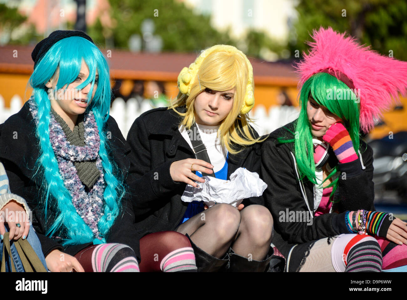 Junge Mädchen verkleidete sich als Punk-Rocker mit bunten Perücken in Nizza Frankreich Stockfoto