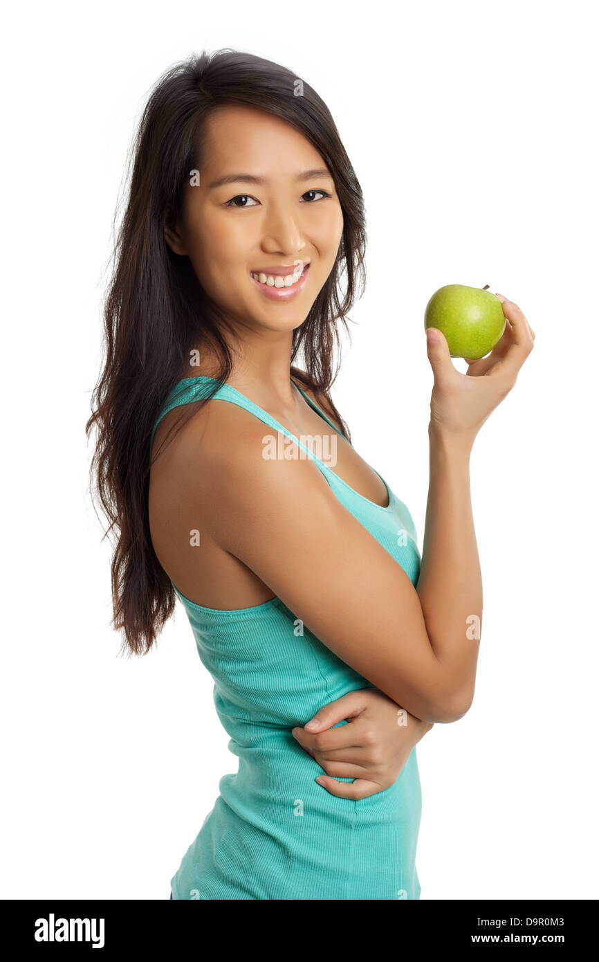 Schöne asiatische Frau lächelt und hält einen Apfel Stockfoto