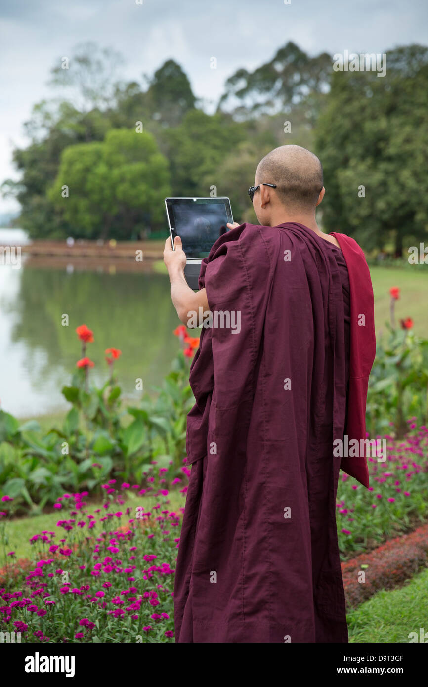 ein Mönch mit einem Tablet, Kandawgyi Gärten, Pyin Oo Lwin, Myanmar (Burma) Stockfoto