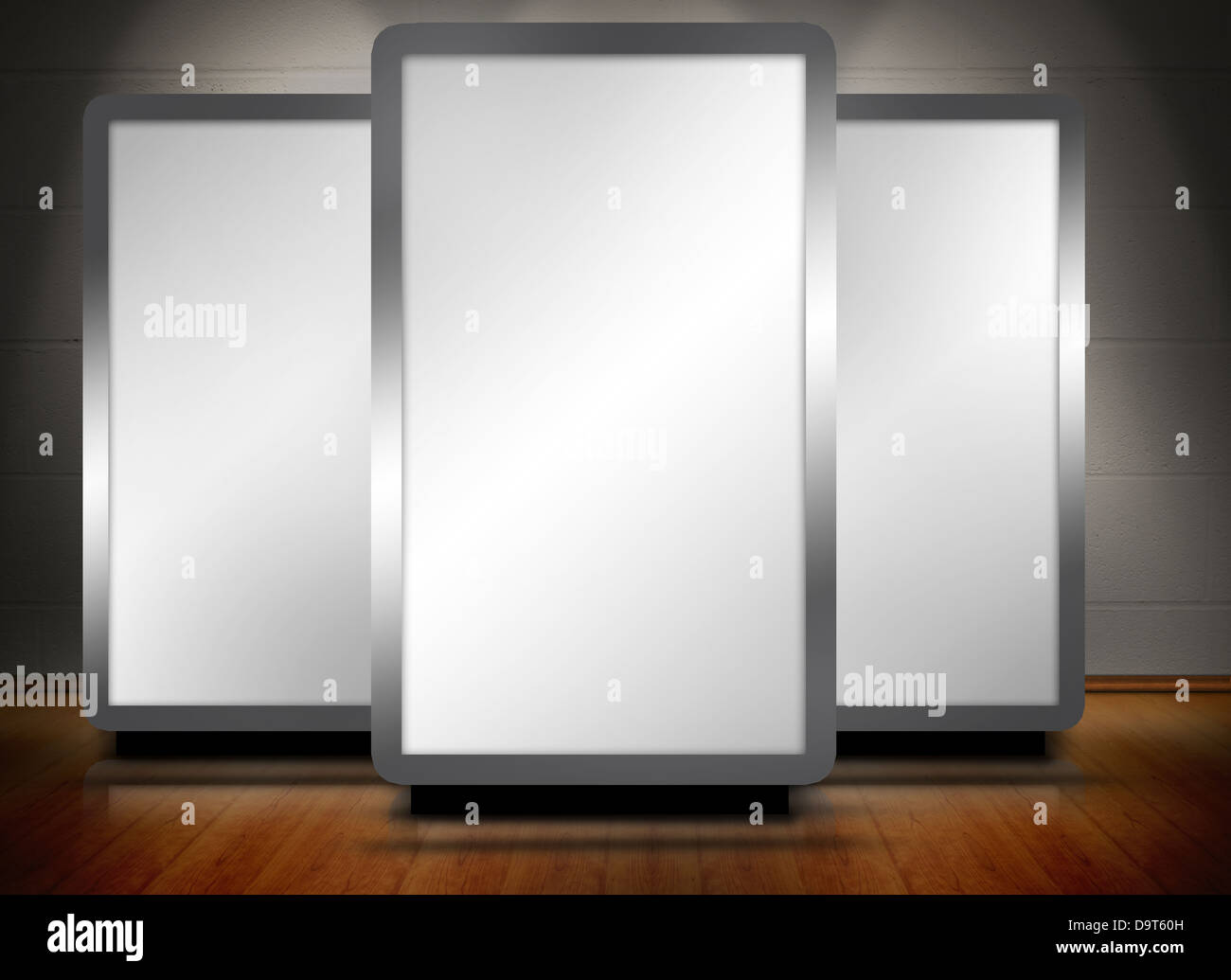 Drei leere Bildschirme stehend auf Holzboden Stockfoto