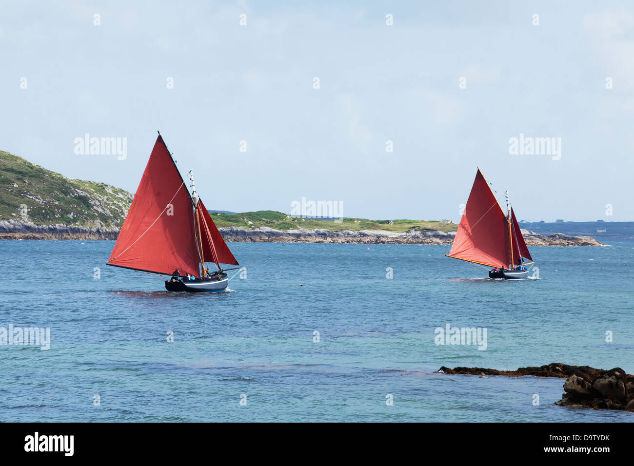 Zwei rote Segelschiffe in Roundstone Regatta; Roundstone County Galway, Irland Stockfoto