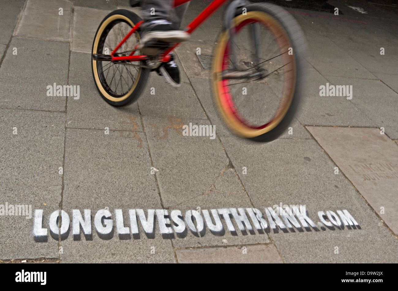 Ein BMX-Fahrer springt über eine Schablone, die Werbung der Website-Url-longlivesouthbank.com. Stockfoto
