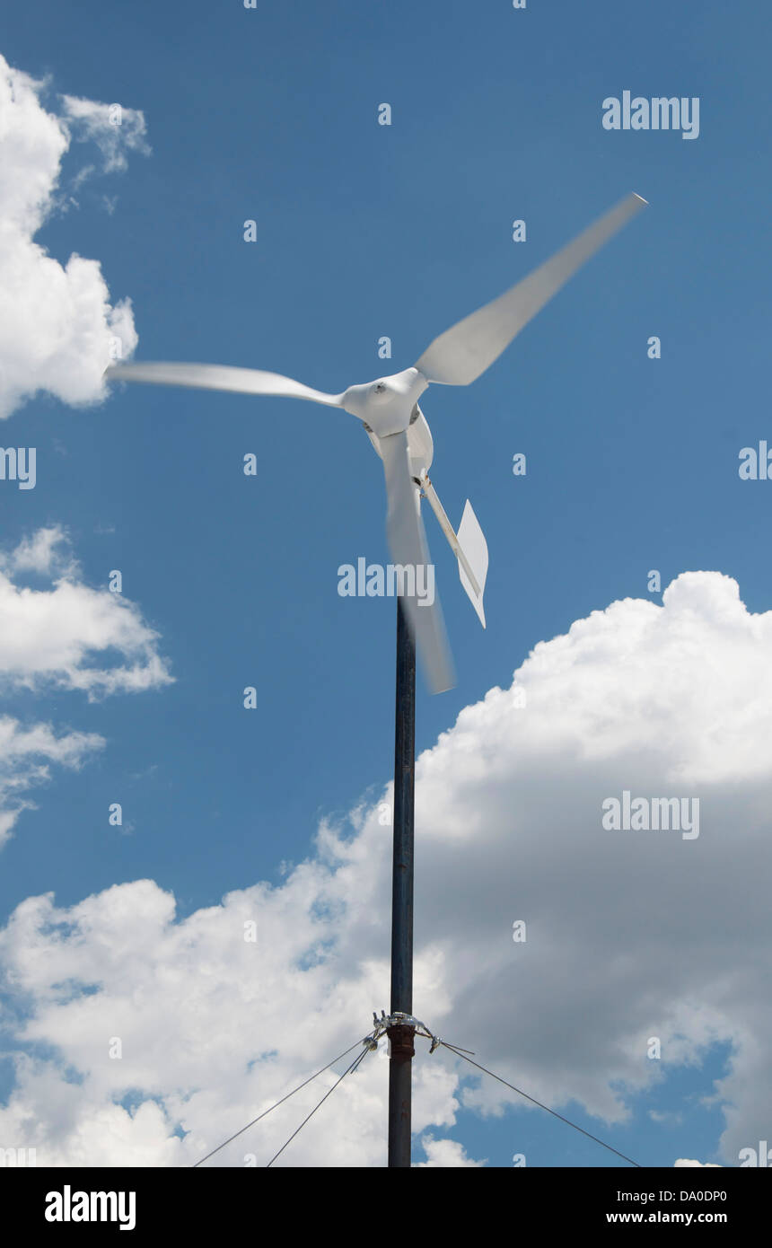 Energie erzeugenden weißer Windgenerator mit blauem Himmel und weißen Wolken an einem sonnigen Tag. Stockfoto