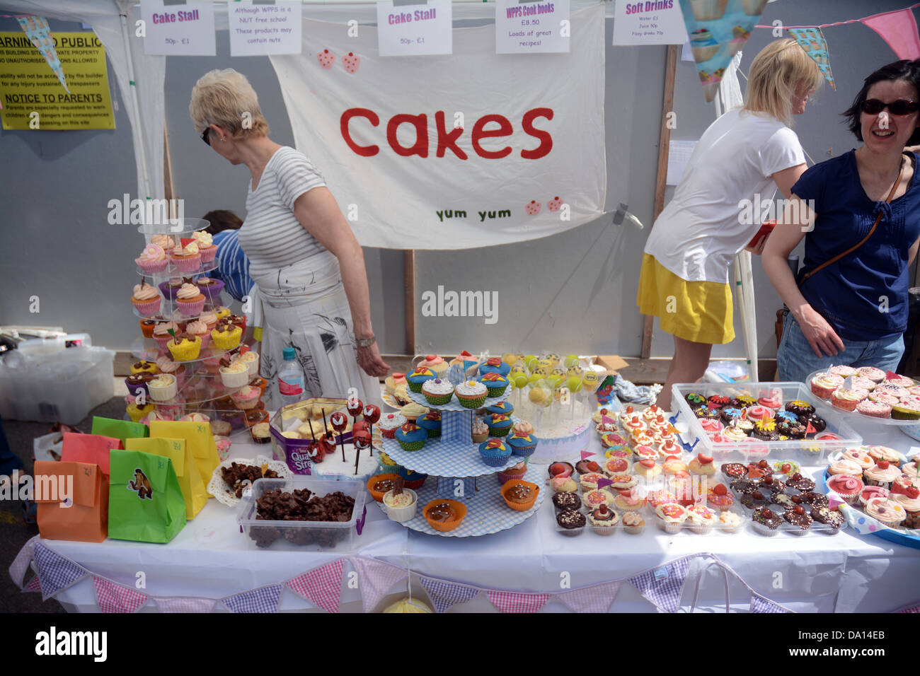 Hausgemachte Kuchen auf den Verkauf von Freiwilligen Müttern auf einen Stall in einer Grundschule Summer fair Stockfoto