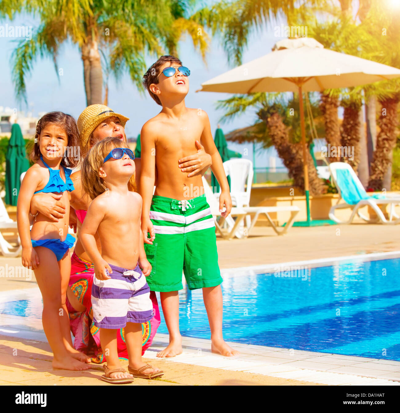 Niedliche glückliche Familie Spaß Pool auf tropischen Luxus-Resort, Mutter mit Kindern, die nach oben Himmel, Sommerferien Stockfoto