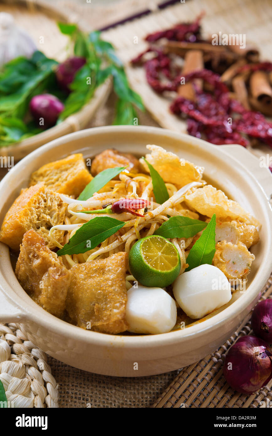 Scharf und würzig singapurischen Curry Nudel oder Laksa mir im Tontopf, Dekoration Einrichtung dienen mit Stäbchen. Singapur-Küche. Stockfoto