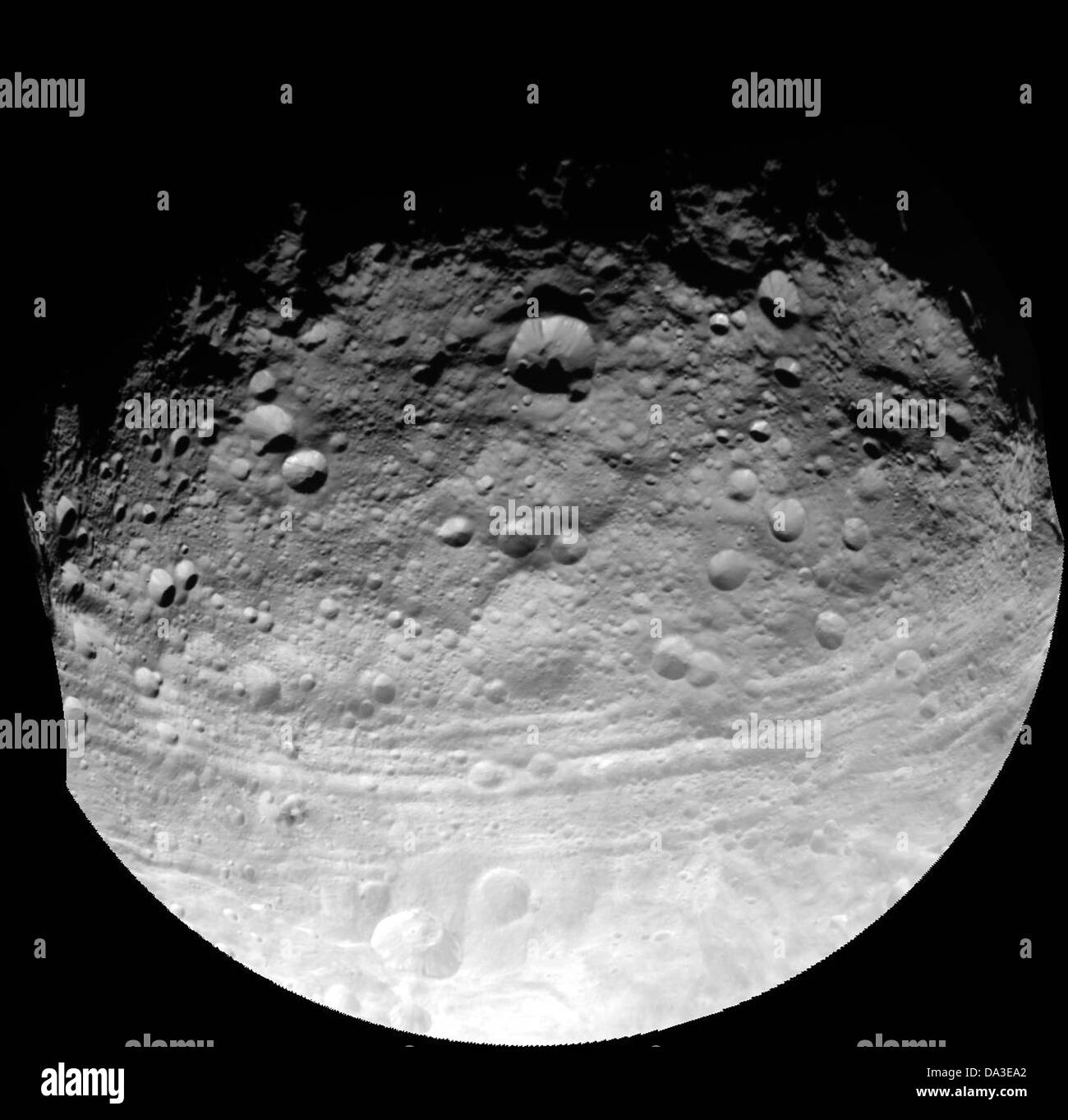 Raum Asteroiden Vesta aufgenommen durch die Raumsonde Dawn zeigt Einschlagskrater in verschiedenen Größen und Tröge parallel zum Äquator Stockfoto