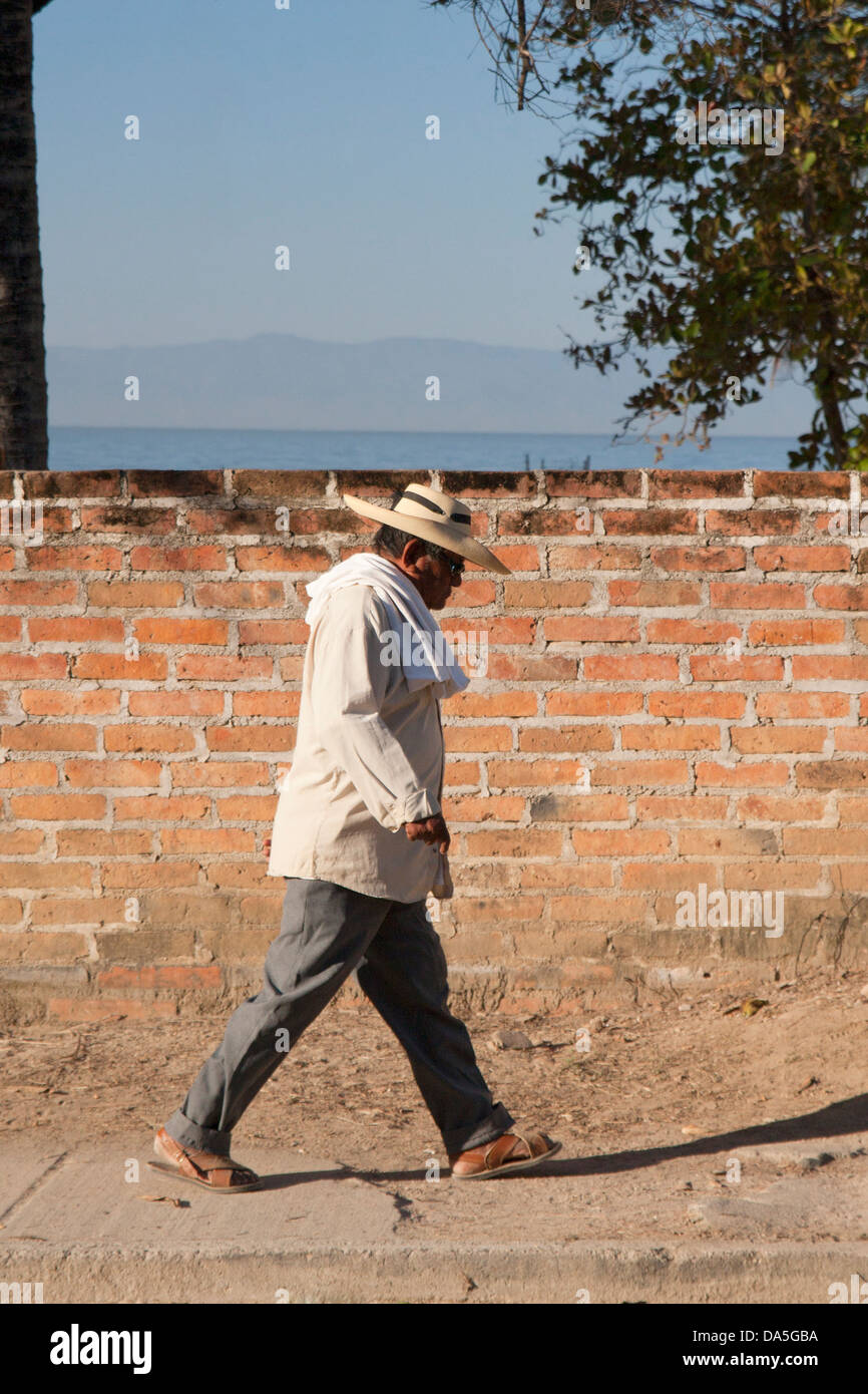Mexikanische Mann zu Fuß auf einer Straße von Bucerias, Bundesstaat Nayarit, Mexiko. Stockfoto