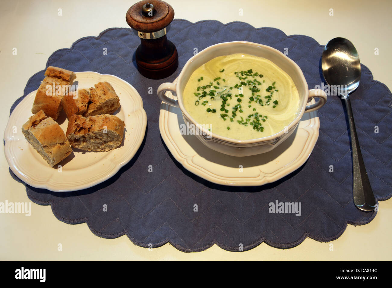 Liebstöckel-Suppe mit Schnittlauch und knusprigem Brot Stockfoto