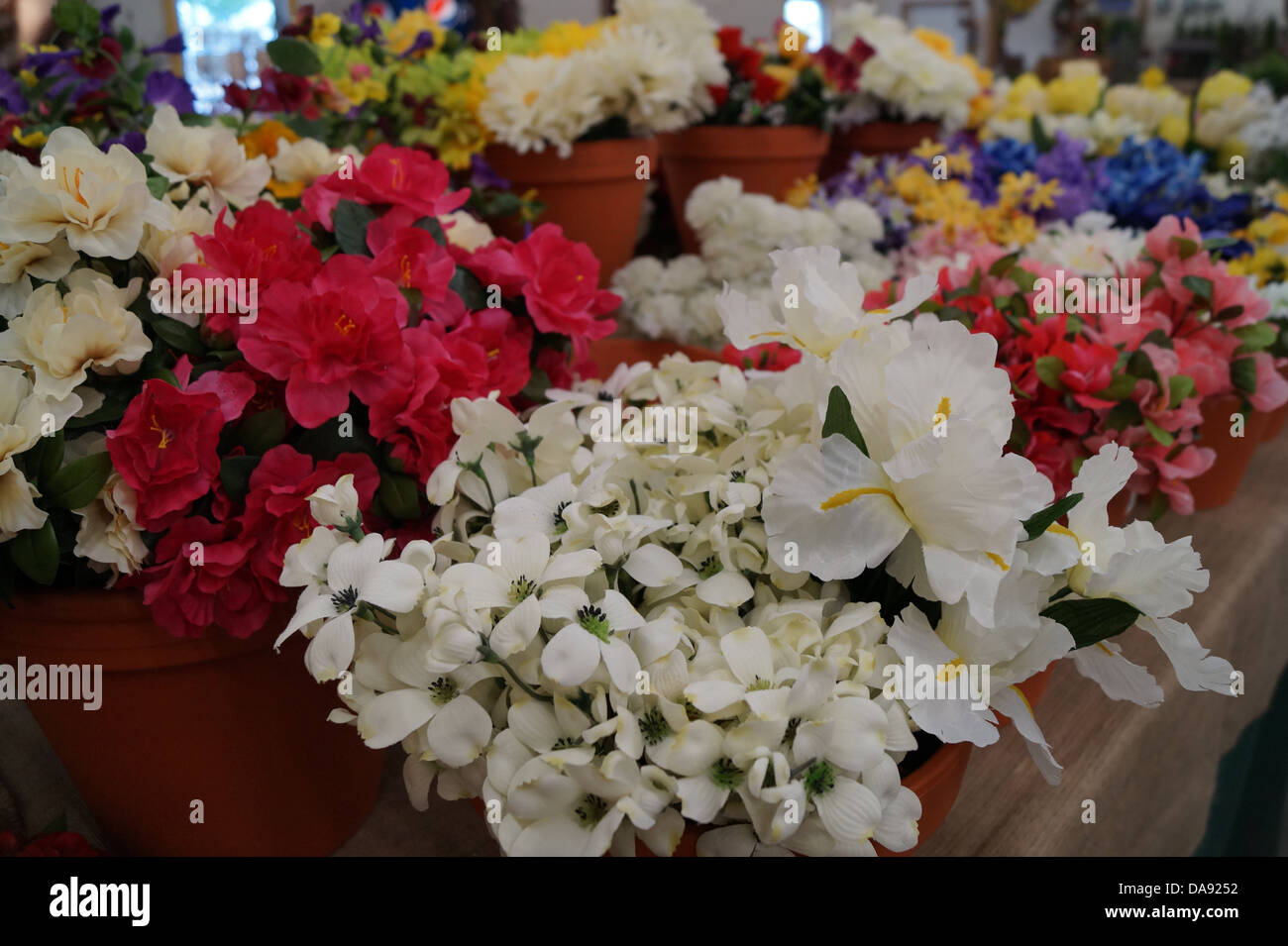 Gefälschte Blume zum Verkauf in einer Reihe angeordnet. Stockfoto