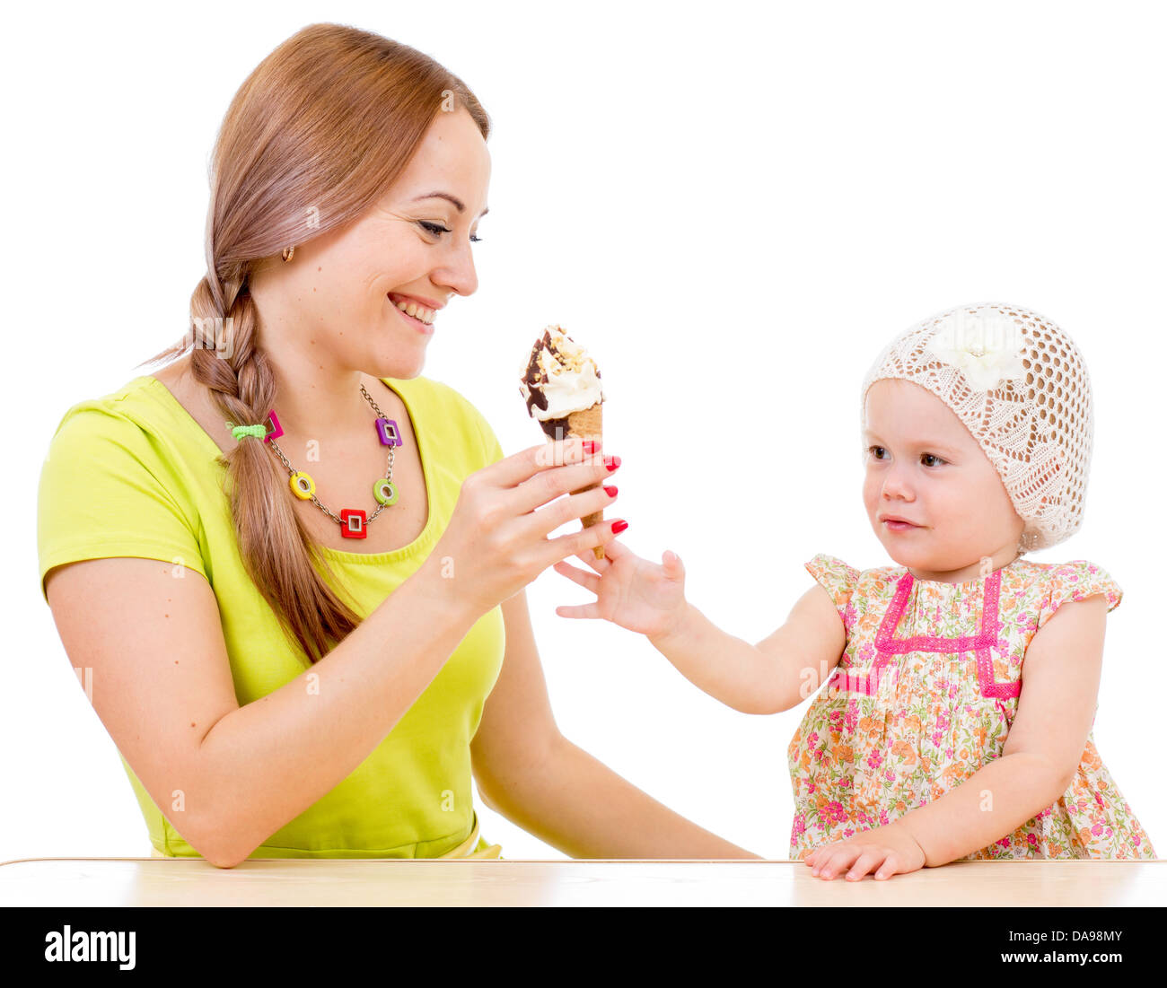 Mutter, Eis, kleines Mädchen sitzt am Tisch, die isoliert auf weiss Stockfoto