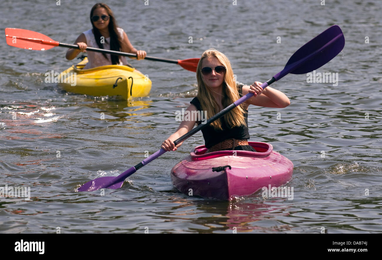 15-jähriges Mädchen (im Vordergrund), Kanufahren auf der Heide Teich im Sommer, Petersfield, Hampshire, UK. Stockfoto