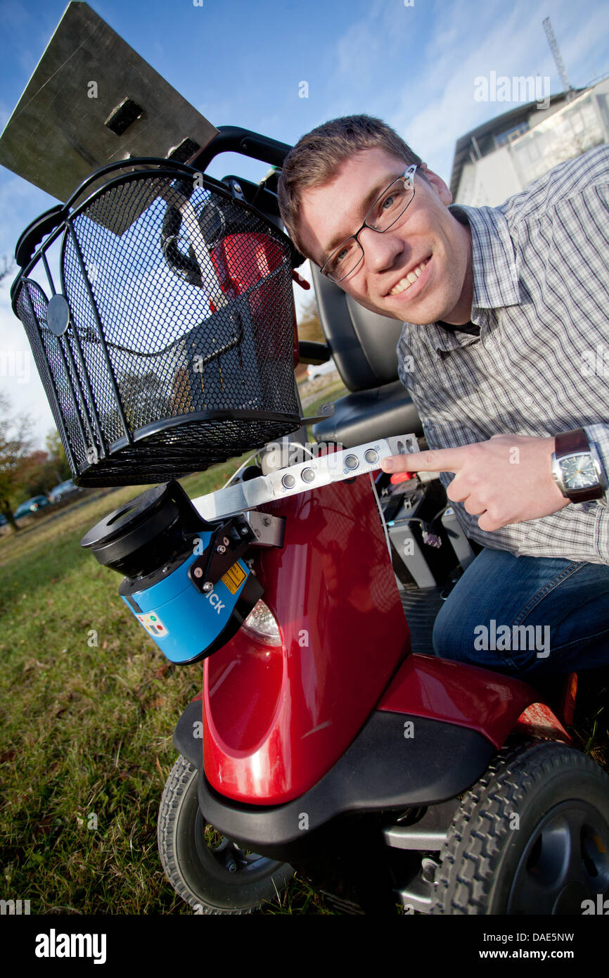 Der postgraduale Daniel Eck verweist auf Sensoren von einem Steuergerät eine neue intelligente Senior-Scooter entwickelt am Institut für Informatik und Robotik in Würzburg, Deutschland, 25. Oktober 2011. Der Scooter benannt Fussgängerzone Hilfe Fahrzeug ist in der Lage selbstständig fahren und Hindernisse zu vermeiden. Foto: Daniel Karmann Stockfoto