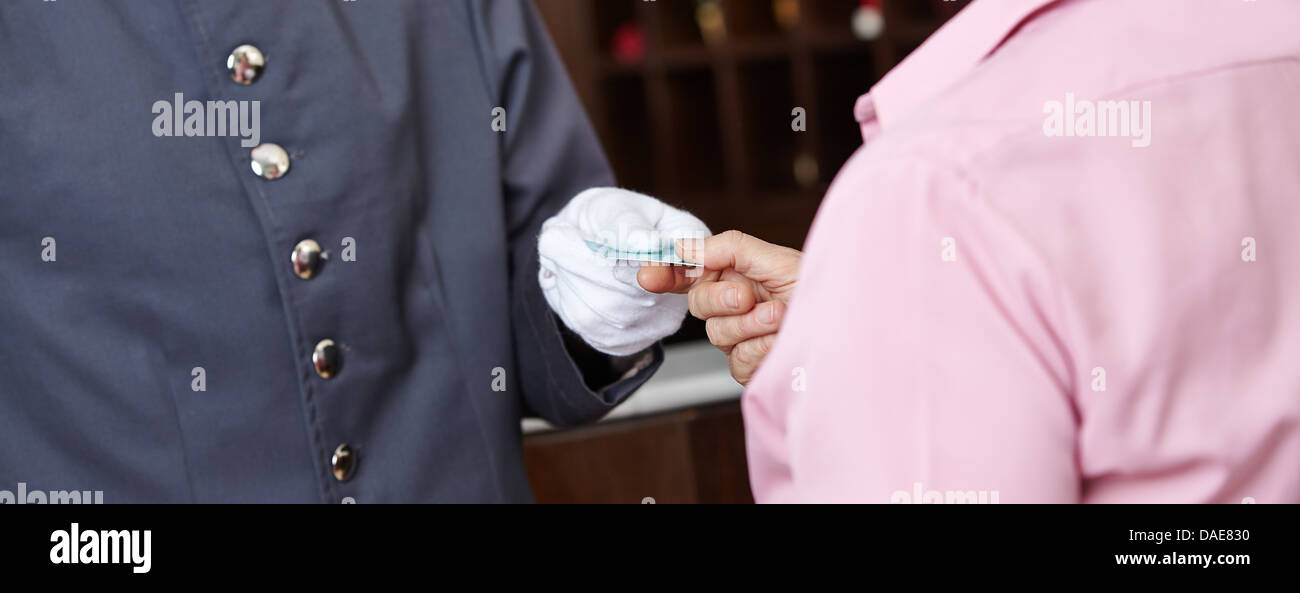 Hand eines Concierge Frau Hotel Zimmerkarte verleihen Stockfoto