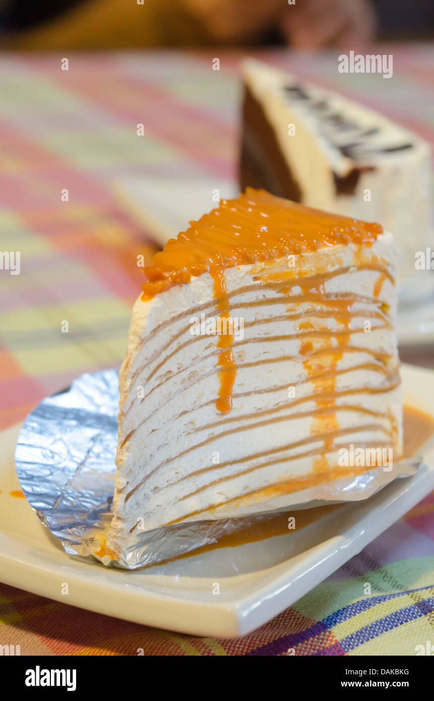 Nahaufnahme orange Crêpe Kuchen auf weißen Teller Stockfoto
