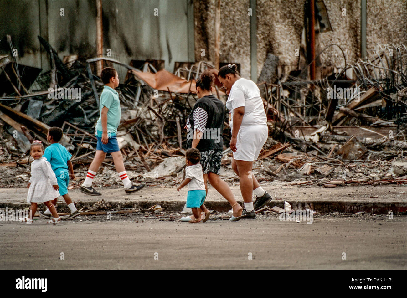 Hispanische einheimischen Fuß vorbei an den Ruinen von einem Brand beschädigt-Shop in South Central Los Angeles nach 1992 Rodney King Race Riot. Stockfoto
