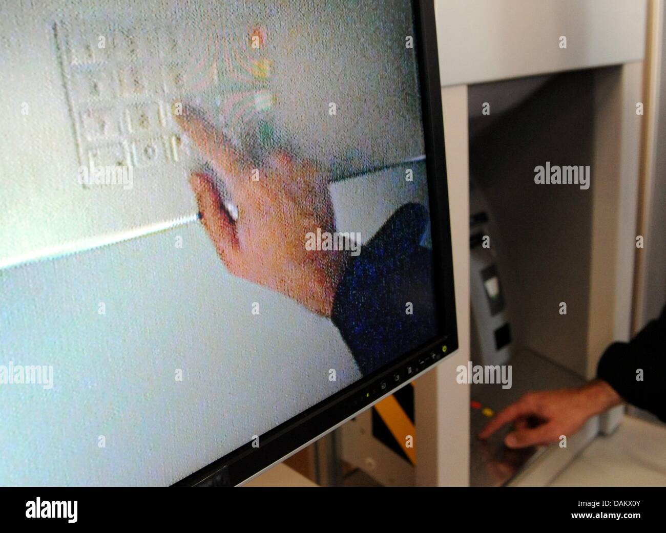 Ein Polizist des BKA zeigt wie Geldautomaten während einer Pressekonferenz in Berlin, Deutschland, 10. Mai 2011 bearbeitet werden können. In diesem Fall eine kleine Kamera erbaute Ausspähen der Pin-Codes und die Daten übermitteln. Im Jahr 2010 registriert Deutschland 3183 Angriffe auf Geldautomaten, was eine Steigerung von 55 Prozent im Vergleich zu 2009 bedeutet. Foto: Maurizio Gambarini Stockfoto