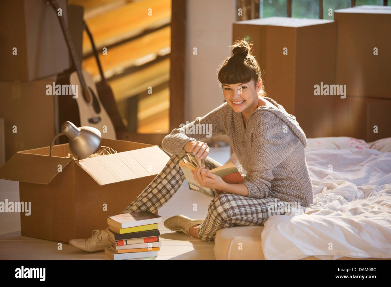 Woman Holding Buch im Bett Stockfoto