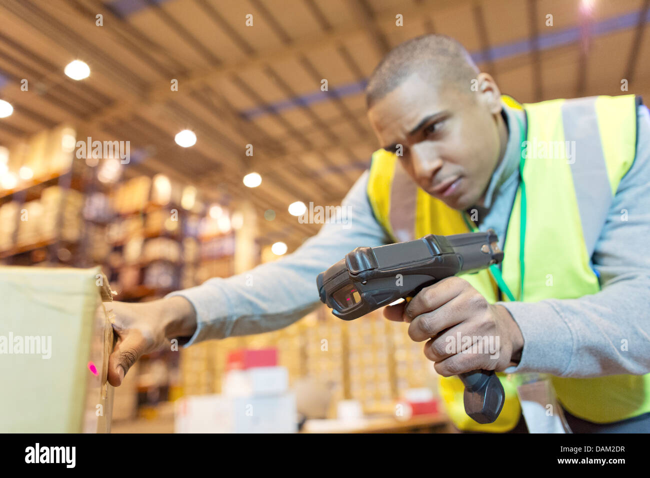 Arbeiter Scan Kisten im Lager Stockfoto