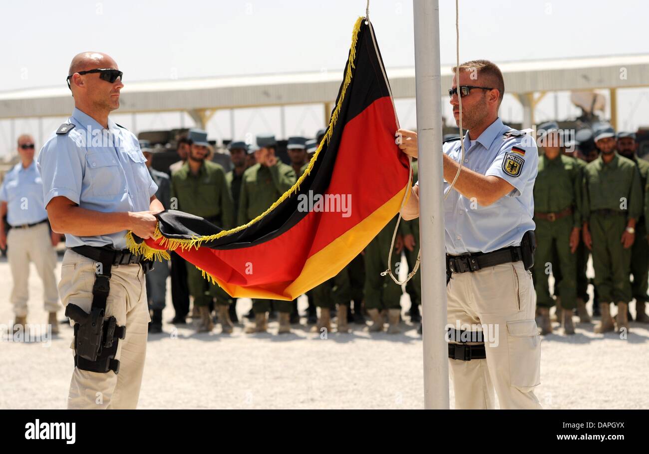Deutsche Polizisten senken die deutsche Flagge nach einem Tag voller