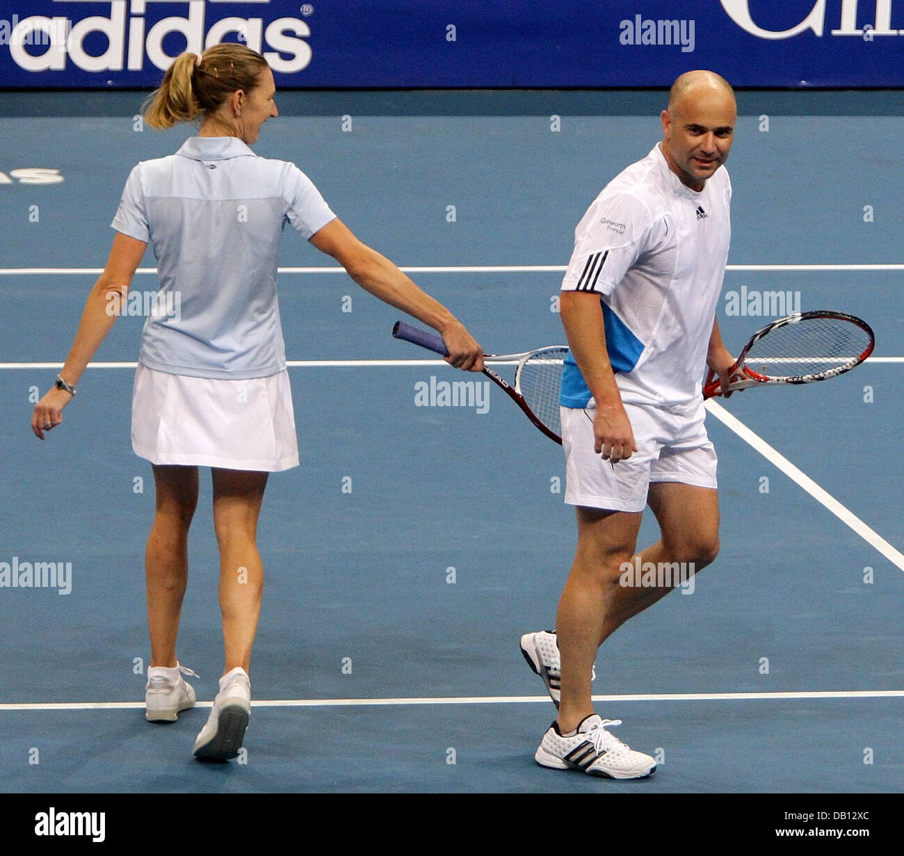 Ehemaliger Tennis, die pro deutsche Steffi Graf (L) mit ihrem Mann und Ihrem Traumpartner US Andre Agassi (R) während ihrer gemischten Doppel Benefizspiel gegen belgische pro Justine Henin und ehemaligen pro jugoslawischen Goran Ivanisevic Stadium der SAP Arena Mannheim, Deutschland, 27. Oktober 2007 flirtet. Die erwarteten Erlöse von 500.000 bis 750.000 Euro gespendet die? Children for Tomorrow? Foundat Stockfoto