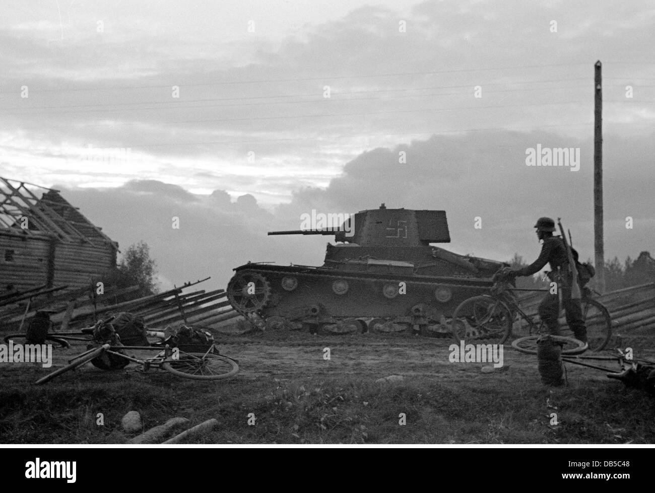 Ereignisse, Zweiter Weltkrieg, Finnland, Karelien, Finnische Truppen mit gefangenem sowjetischen Panzer T-26 Vormarsch, wahrscheinlich 1941, Fahrrad, Fahrräder, 20. Jahrhundert, historisch, Militär, Finnisches Staatswappen, Hakenkreuze, Dorf, Uniformen, Uniform, T26, T 26, Fortsetzung Krieg 1941 - 1944, Soldat, Soldaten, 1940er Jahre, Menschen, Zusatzrechte-Clearences-nicht vorhanden Stockfoto