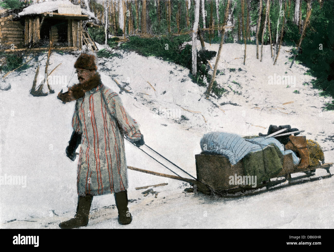 Prospector im Klondike mit seiner Ausrüstung und Schlitten, 1898. Handcolorierte halftone Wiedergabe einer Fotografie Stockfoto