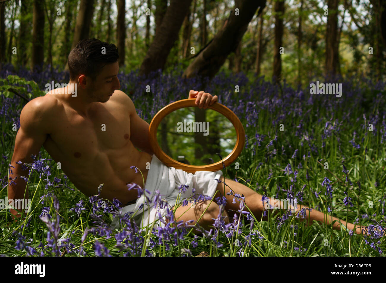 Ein männliches Modell Verlegung in einem Lavendelfeld und Spiegel. Stockfoto