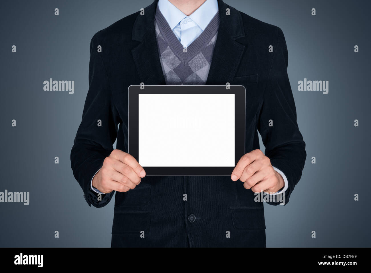 Gut aussehend Geschäftsmann im schwarzen Anzug mit modernen digital-Tablette mit leeren Bildschirm. Studio gedreht. Auf dunklem Hintergrund isoliert Stockfoto