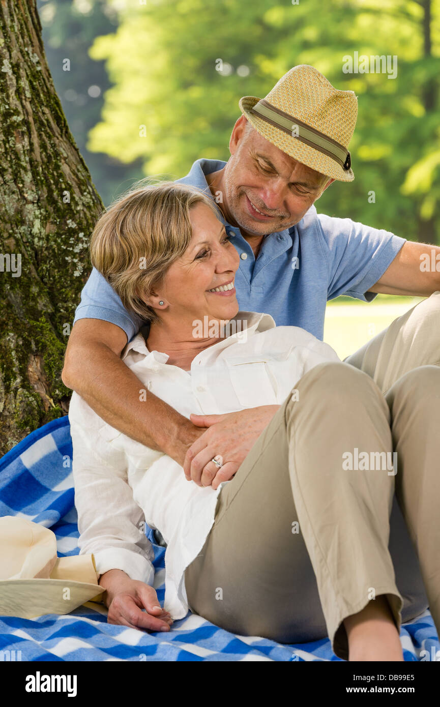 Glückliche ältere Frau und Mann umarmt im park Stockfoto