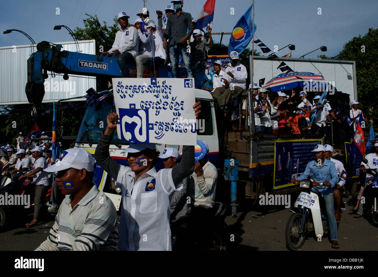 Phnom Penh, Kambodscha im Juli. 26., 2013. Sam Rainsy Anhänger mit Schildern, wie sie durch die Straßen von Phnom Penh fahren. Sam Rainsy ist seit 2009 im Exil in Frankreich. Er war eine königliche Begnadigung gewährt, des Königs von Kambodscha & am 19. Juli 2013 wieder in Kambodscha. Bildnachweis: Kraig Lieb / Alamy Live News Stockfoto