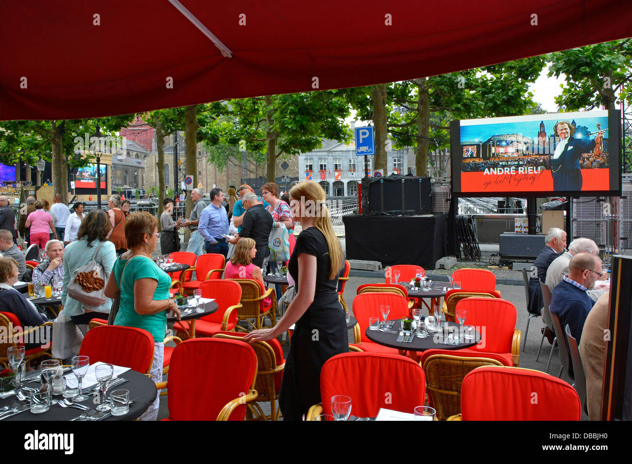 Maastricht City eine von vielen Bars und Restaurants eine Seite Vrijthof Square Publikum schließt das Essen ab, bevor Sie André Rieu Konzert TV Repeater Bildschirme sehen Stockfoto