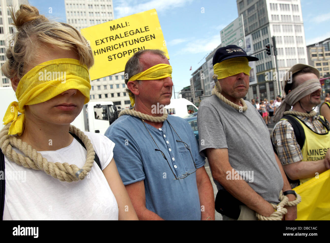 Aktivisten von Amnesty International zur Sensibilisierung für die Situation in Mali und der Bundestagswahl innerhalb des Landes am Potsdamer Platz in Berlin, Deutschland, 28. Juli 2013 zu protestieren. Amnesty international will sensibilisieren für den alarmierenden Status des Landes bezüglich der Menschenrechte, vor allem die steigende Zahl von Hinrichtungen in dem westafrikanischen Land. Foto: WOLFGANG KUMM Stockfoto