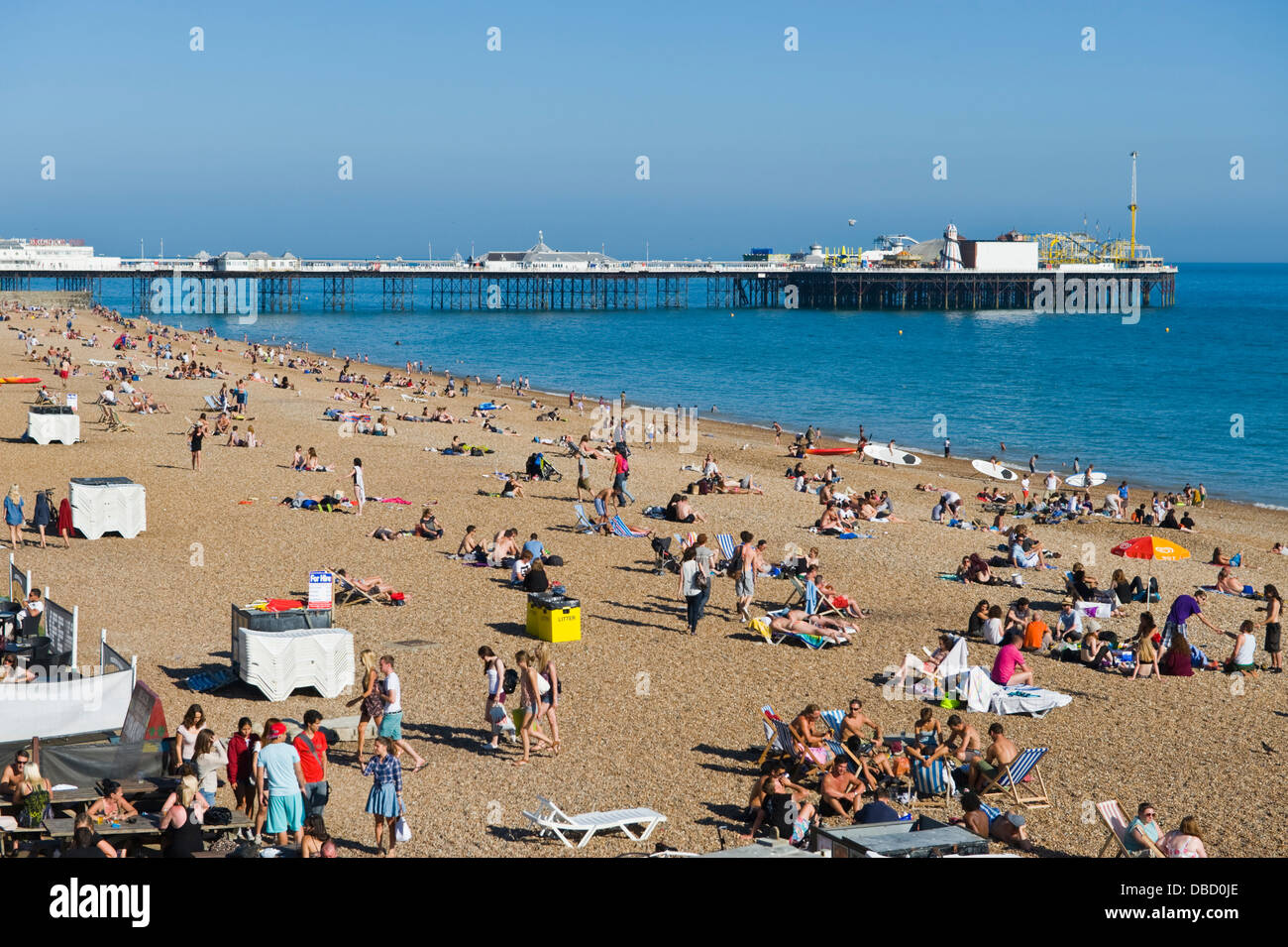 Urlauber entspannen Sie im Sonnenschein am Strand von Brighton East Sussex England UK Stockfoto
