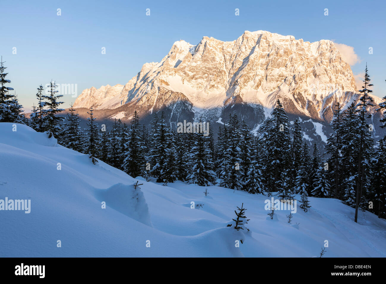 Österreich, Tirol, Ehrwald. Wetterstein Bergkette mit Mt. Zugspitze gesehen aus dem Westen bei Sonnenuntergang im Winter. Stockfoto
