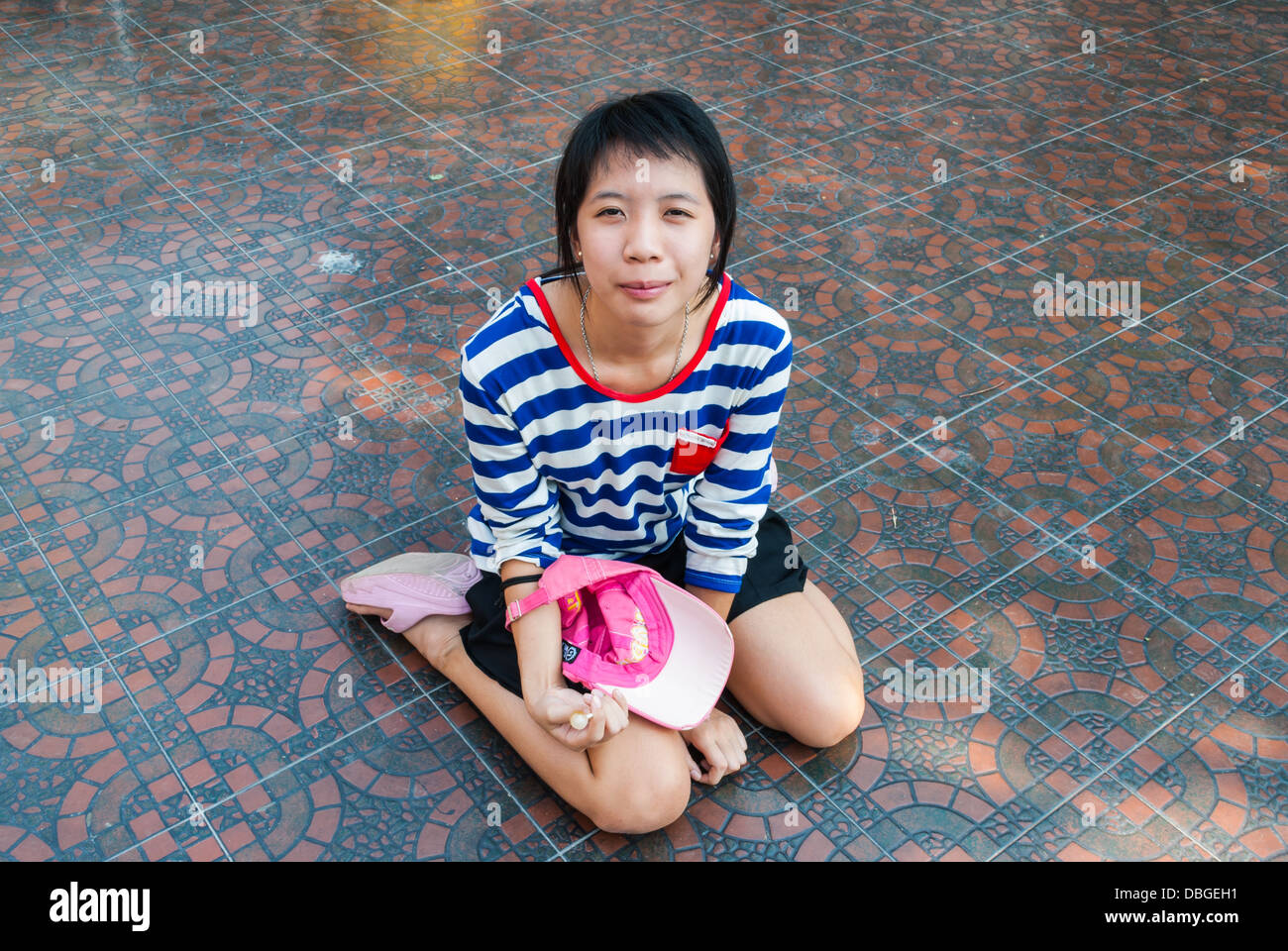 Asiatische Thai-Mädchen auf dem Boden sitzen. Stockfoto
