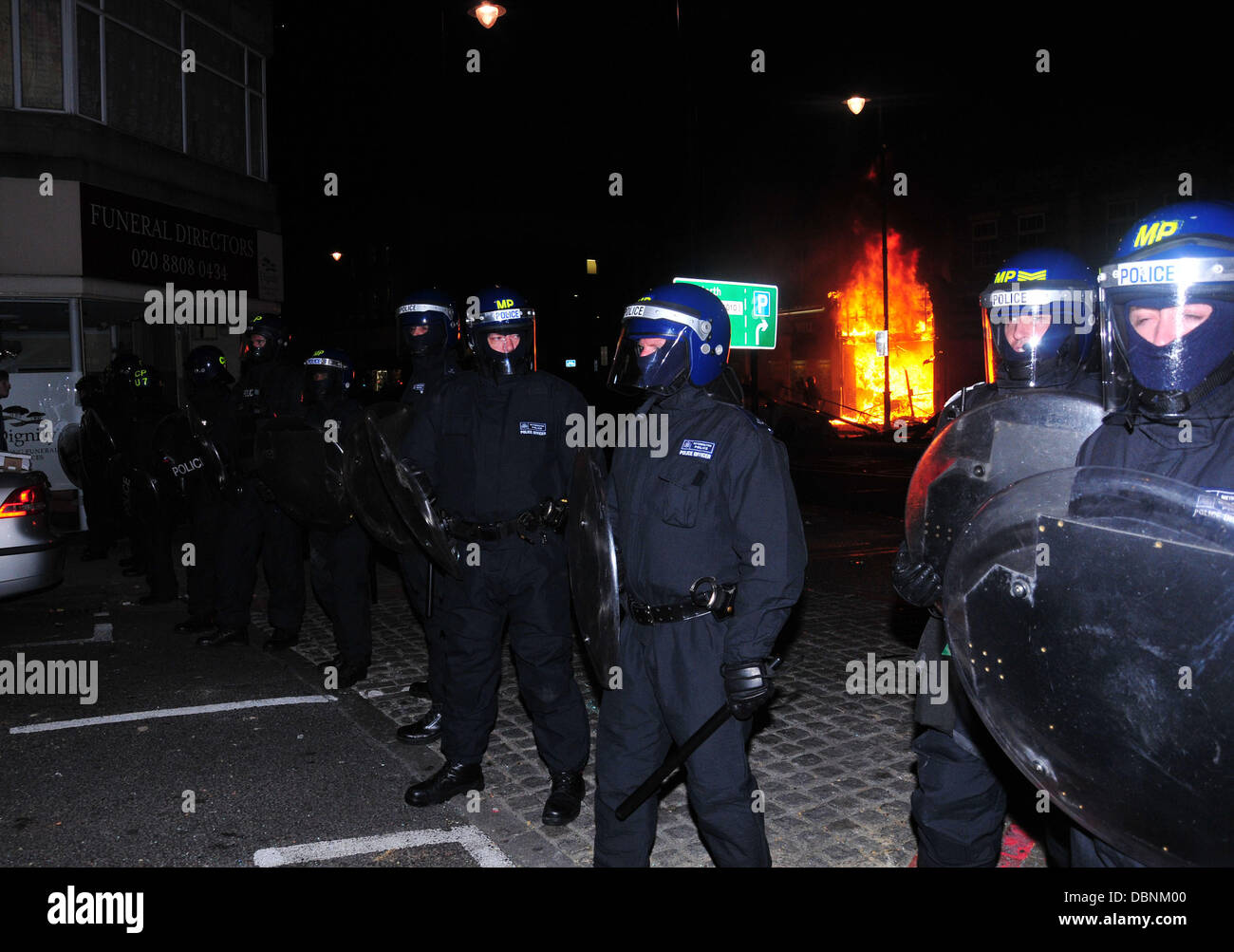 Randalierer in Tottenham, Nord-London, haben zündeten zwei Polizeiwagen, ein Doppeldeckerbus und verschiedene Geschäfte nachdem eine Demonstration vor der örtlichen Polizeistation gewalttätig geworden. 120 Demonstranten marschierten anspruchsvolle Antworten, nachdem Mark Duggan durch Gewehr getötet wurde Stockfoto