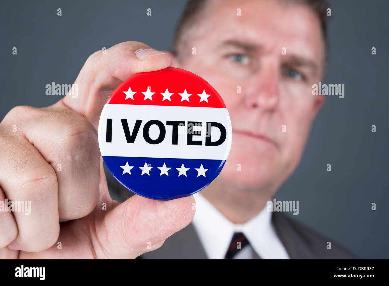 Ein Mann, gestimmt hält seine Stimmrechte Abzeichen Anstecknadel. Stockfoto