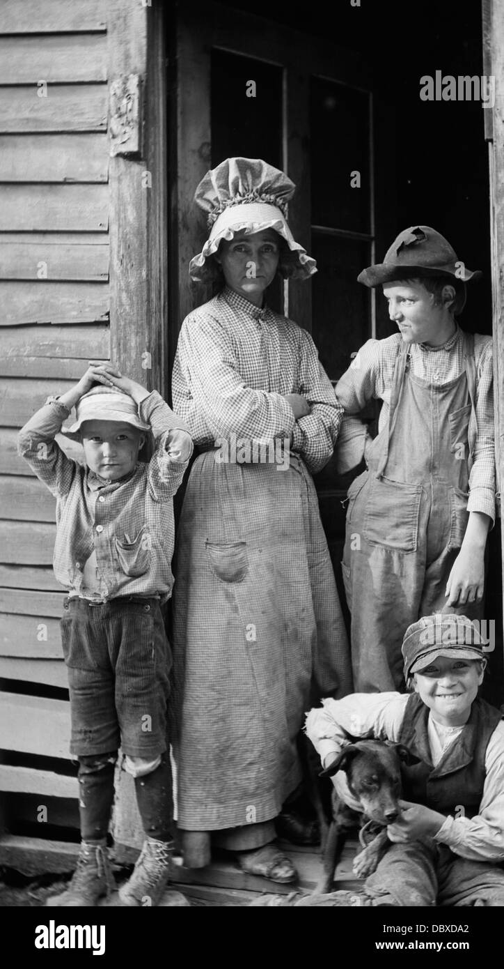 1900S 1910S ARMEN LÄNDLICHEN FAMILIE MUTTER UND SEINEN DREI SÖHNEN IN KABINE TÜR OZARK BERGE IN MISSOURI Stockfoto