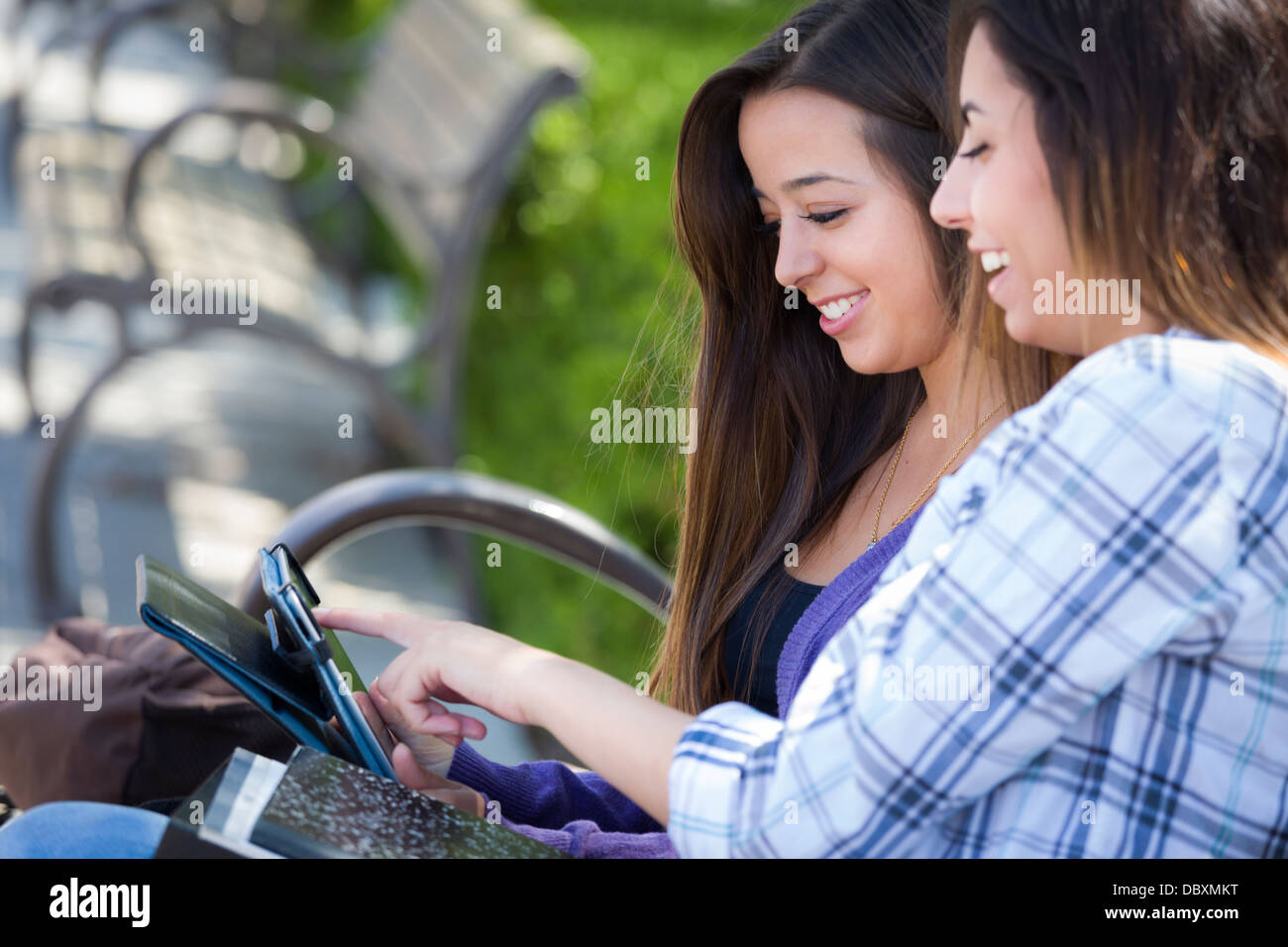 Zwei glückliche Mischlinge Studenten mit Touch Pad Computer außerhalb zusammen auf dem Campus. Stockfoto