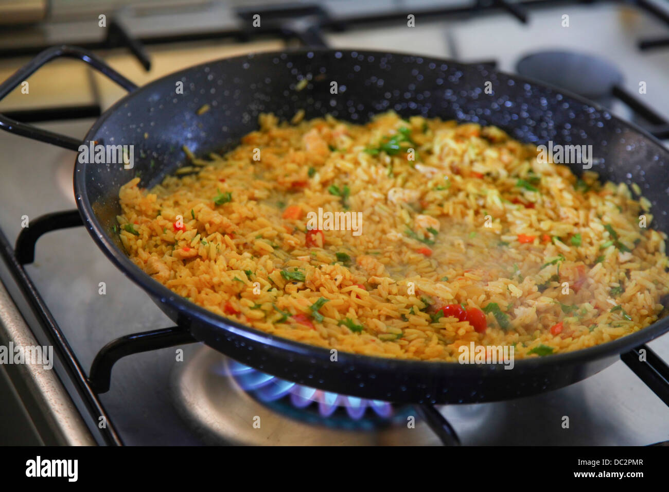 Paella, (Paeia) ein valencianischen Reisgericht Kochen auf dem Herd Stockfoto