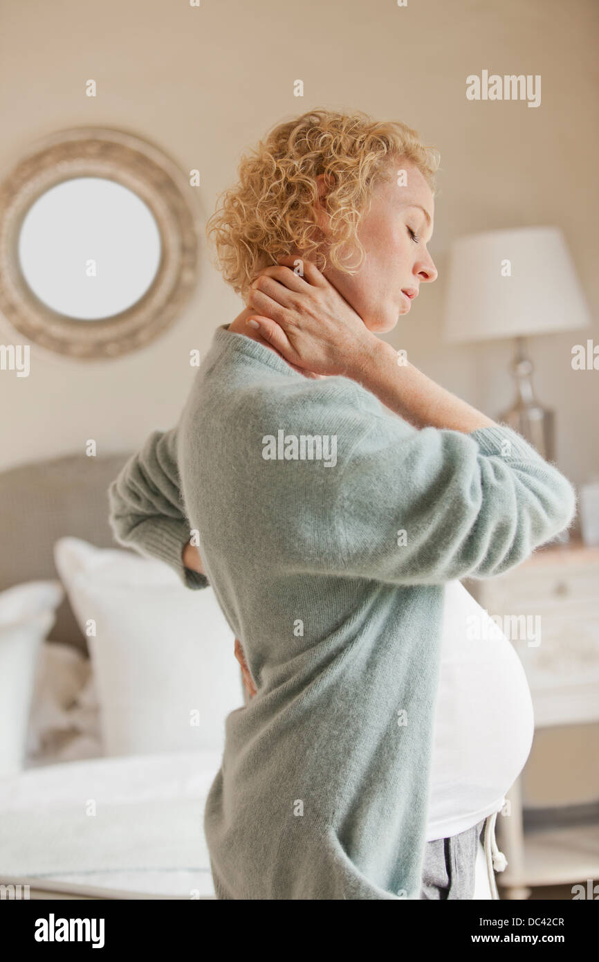 Schwangere Frau Holding Nacken und Rücken Schmerzen Stockfoto