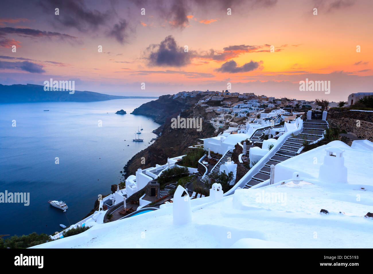 Die Sonneneinstellungen über das schöne Dorf Oia auf der Insel Santorin in Griechenland. Stockfoto