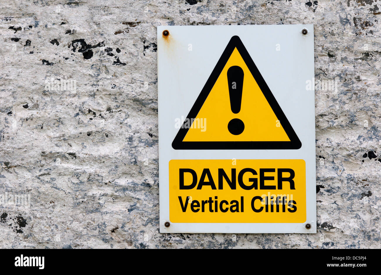 Ein Schild warnt vor der Gefahr von senkrechten Felswänden. Stockfoto