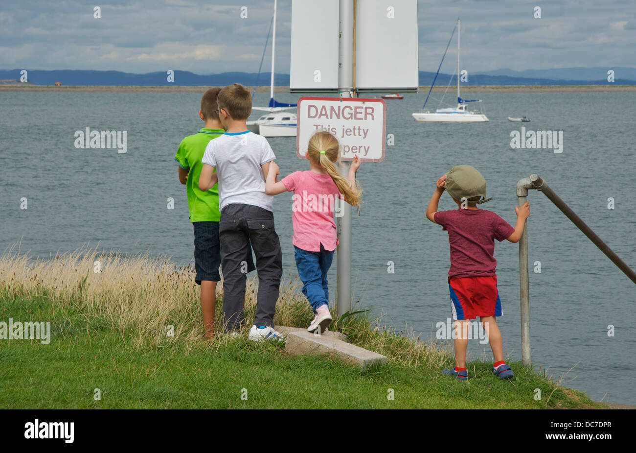 Vier Kinder spielen auf Piel Island, South Lakeland, Cumbria, England uk Stockfoto