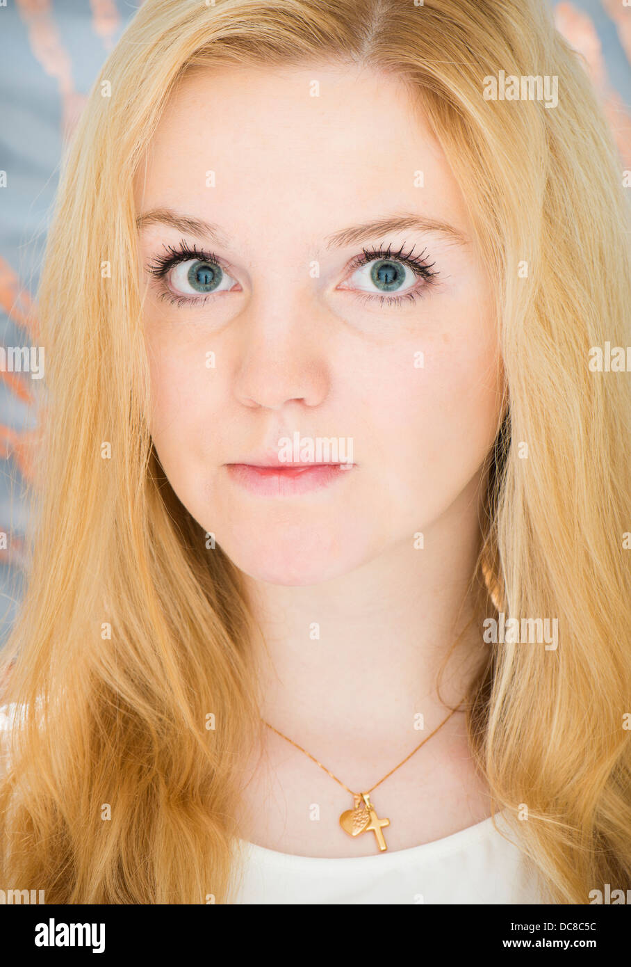 Junge blonde weibliche Teenager Blick in die Kamera mit ernsten Ausdruck Stockfoto
