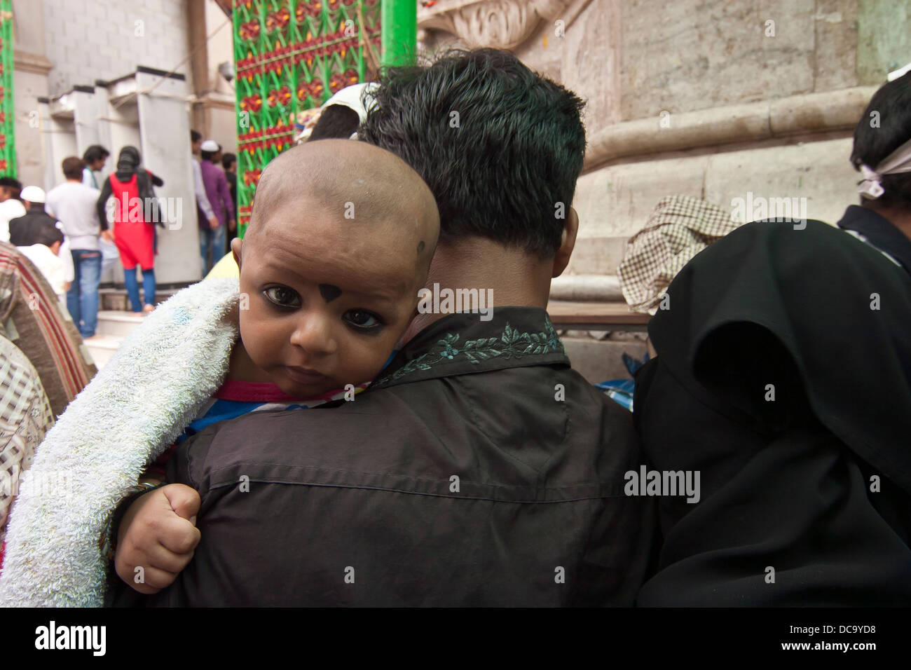 Baby in den Armen des Vaters durchgeführt wird zum Schrein in Ajmer Rajasthan Indien gebracht Stockfoto