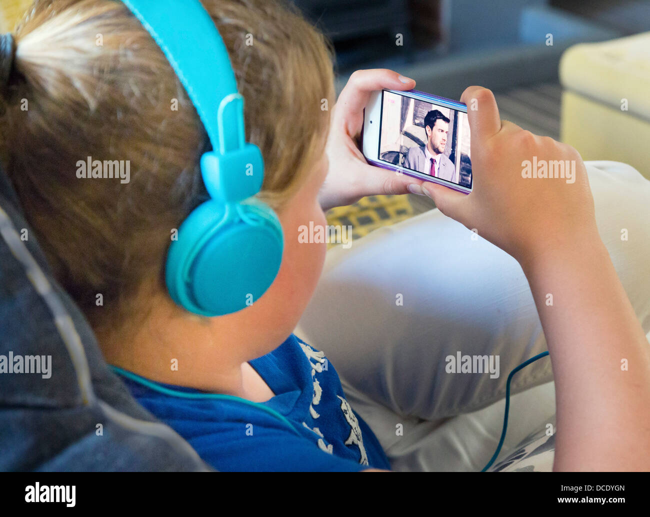 junge Mädchen beobachten Film / tv auf dem Smartphone Stockfoto
