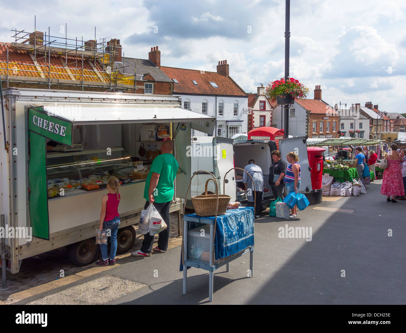 Shopper, Käse und Fisch von Stände auf dem Wochenmarkt in Kirkbymoorside North Yorkshire kaufen Stockfoto